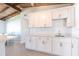 Kitchen area showcases bright white cabinets, quartz counters, and a seamless connection to dining at 2703 Avenue B, Holmes Beach, FL 34217