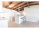 Open concept kitchen with a breakfast bar, stylish stools, and wood beamed ceilings to the dining area at 2703 Avenue B, Holmes Beach, FL 34217