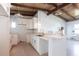 Kitchen featuring white cabinetry, a peninsula counter, and wood ceilings with contemporary lighting at 2703 Avenue B, Holmes Beach, FL 34217