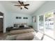 Airy main bedroom with neutral colors, a ceiling fan, and sliding glass door to a pool at 2703 Avenue B, Holmes Beach, FL 34217