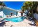Inviting in-ground pool surrounded by lush landscaping and a light blue exterior at 2703 Avenue B, Holmes Beach, FL 34217