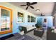 Inviting porch with comfortable seating, ceiling fans, and lots of light for relaxing at 2703 Avenue B, Holmes Beach, FL 34217