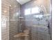 Modern tiled shower with glass door and shower head with a built in bench at 2703 Avenue B, Holmes Beach, FL 34217