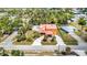An aerial shot showcases a home with a long driveway, mature landscaping, and unique architectural design at 280 W Cowles St, Englewood, FL 34223