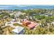 Scenic aerial shot of a home near the water, surrounded by lush greenery and other residential properties at 280 W Cowles St, Englewood, FL 34223