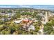 Panoramic aerial view of a neighborhood with scattered homes, lush trees, and waterways in the backdrop at 280 W Cowles St, Englewood, FL 34223