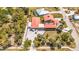 Aerial view of the home highlighting the roof, outdoor area, and lush landscaping, along with the sparkling swimming pool nearby at 280 W Cowles St, Englewood, FL 34223