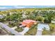 An aerial perspective reveals the well-maintained property with a metal roof and neighboring residences at 280 W Cowles St, Englewood, FL 34223