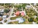 An aerial view displays a home with a fenced yard next to a neighboring home featuring a screened-in pool at 280 W Cowles St, Englewood, FL 34223