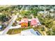 Overhead view captures a home with a connecting building, a fenced yard, and surrounding trees at 280 W Cowles St, Englewood, FL 34223