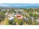 A bird's eye view of an orange house, surrounded by trees, positioned near a body of water at 280 W Cowles St, Englewood, FL 34223