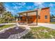 Property featuring a cozy covered patio, a manicured lawn, and an ornate statue at 280 W Cowles St, Englewood, FL 34223