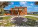 Property featuring a cozy covered patio, a manicured lawn, and an ornate statue at 280 W Cowles St, Englewood, FL 34223