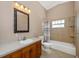 Bright bathroom with a shower and vanity with wood cabinets at 280 W Cowles St, Englewood, FL 34223
