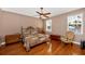 Cozy bedroom with hardwood floors, a ceiling fan, and natural light from two windows at 280 W Cowles St, Englewood, FL 34223