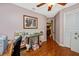 Bedroom with a ceiling fan, hardwood floors, and an entry view to other rooms at 280 W Cowles St, Englewood, FL 34223