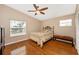 Bedroom features hardwood floors, windows, and a ceiling fan at 280 W Cowles St, Englewood, FL 34223