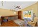 Bonus room with hardwood floors, custom storage shelves, and natural light from a sliding glass door at 280 W Cowles St, Englewood, FL 34223