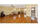 Large bonus room with a sofa, exercise equipment, and hardwood floors at 280 W Cowles St, Englewood, FL 34223