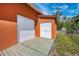 Utility building features a roll-up door and double doors for versatile access and storage at 280 W Cowles St, Englewood, FL 34223