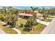 Exterior aerial shot of the home featuring a screened porch, covered parking, and landscaped grounds at 280 W Cowles St, Englewood, FL 34223