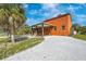 The charming exterior presents a covered patio, verdant lawns, and a lengthy driveway at 280 W Cowles St, Englewood, FL 34223