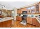 Well-lit kitchen with wood cabinets, stainless steel range, and open design at 280 W Cowles St, Englewood, FL 34223