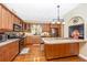 Spacious kitchen boasts stainless steel appliances, wood cabinets, and a tile island at 280 W Cowles St, Englewood, FL 34223