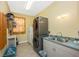 Functional laundry room featuring a stacked washer/dryer, sink, and storage cabinets at 280 W Cowles St, Englewood, FL 34223