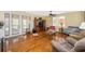 Spacious living room with hardwood floors, ceiling fan, and entertainment center at 280 W Cowles St, Englewood, FL 34223