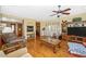 Cozy living room with hardwood floors, ceiling fan, and sliding glass doors at 280 W Cowles St, Englewood, FL 34223