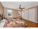 This bedroom features hardwood floors, a ceiling fan, and two windows at 280 W Cowles St, Englewood, FL 34223