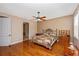 This bedroom features hardwood floors, a ceiling fan, and an ensuite bathroom at 280 W Cowles St, Englewood, FL 34223