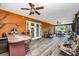This covered patio has a ceiling fan, grill, and french doors at 280 W Cowles St, Englewood, FL 34223