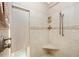 Tiled shower features a built-in seat and shelving at 280 W Cowles St, Englewood, FL 34223