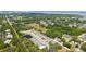 Aerial view of community and surroundings with pond and mature trees at 2926 River Run Way, Bradenton, FL 34208