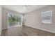 Bright bedroom with hardwood floors, a ceiling fan, and sliding glass doors to a balcony at 2926 River Run Way, Bradenton, FL 34208