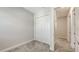 Bright bedroom with neutral walls and carpeted floors plus view of a hallway at 2926 River Run Way, Bradenton, FL 34208