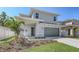 Charming two-story home with grey siding, a two-car garage, and a well-manicured lawn at 2926 River Run Way, Bradenton, FL 34208