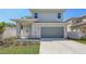 Charming two-story home with grey siding, a two-car garage, and a well-manicured lawn at 2926 River Run Way, Bradenton, FL 34208