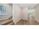 Bright foyer with wood-look floors, a staircase, and an open view to the main living area at 2926 River Run Way, Bradenton, FL 34208