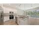 Modern kitchen features granite counters, stainless appliances, and white cabinets at 2926 River Run Way, Bradenton, FL 34208