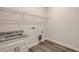 Practical laundry room with granite countertop sink and overhead shelving at 2926 River Run Way, Bradenton, FL 34208