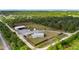 Overhead view of a well-kept property featuring a house, outbuildings, and ample green space at 29527 Maris Dr, Punta Gorda, FL 33982