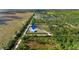 Aerial view of a property featuring a home and an outbuilding on a grassy lot, highlighted with a location pin at 29527 Maris Dr, Punta Gorda, FL 33982