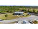 Aerial view featuring the house, outbuildings, parking area, and landscaped yard at 29527 Maris Dr, Punta Gorda, FL 33982