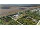 Aerial view of the property showcasing the home, surrounding land, and lush greenery at 29527 Maris Dr, Punta Gorda, FL 33982