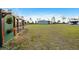 Spacious backyard features a chicken coop and a wide expanse of grass leading up to a metal outbuilding at 29527 Maris Dr, Punta Gorda, FL 33982