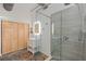 Modern bathroom featuring a glass-enclosed shower, white vanity, concrete floors, and a sliding wooden door closet at 29527 Maris Dr, Punta Gorda, FL 33982