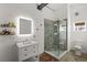 Modern bathroom featuring a glass-enclosed shower, white vanity, concrete floors, and updated vanity mirror at 29527 Maris Dr, Punta Gorda, FL 33982